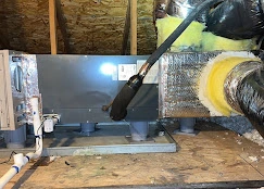 High-efficiency residential furnace installation in attic showing professional setup and qualifying equipment for federal tax credits and utility rebates