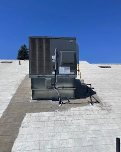 Commercial rooftop HVAC unit installation showing professional mounting and connections